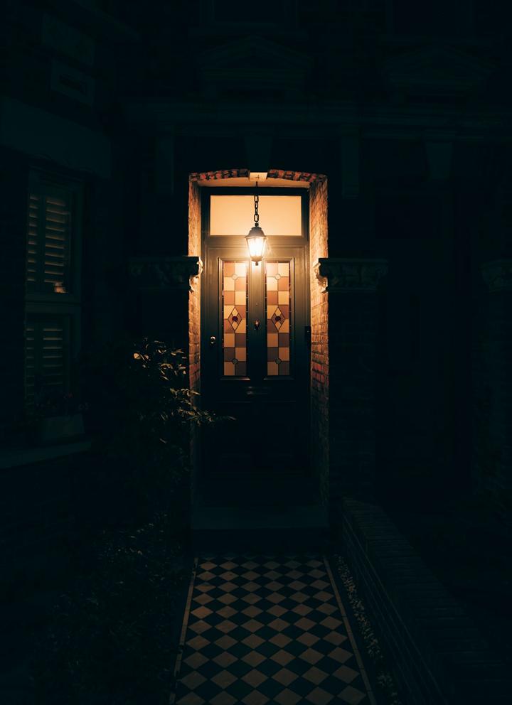 Front door under a lantern at night